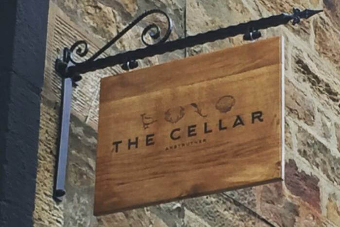 Oak sign for The Cellar Restaurant