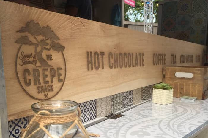 oak sign for The Crepe Shack
