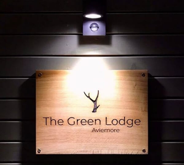 The Green Lodge Aviemore sign lit up
